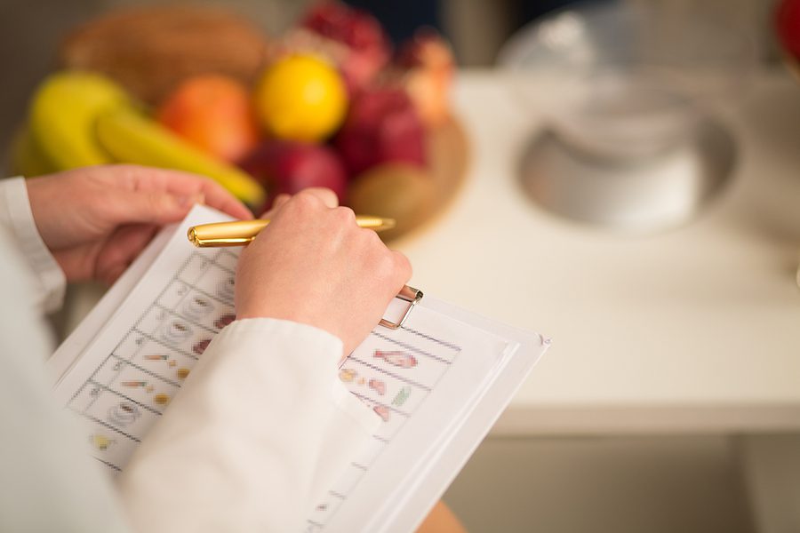 Close up image of note book and pen of dietitian. Healthy life style concept. book