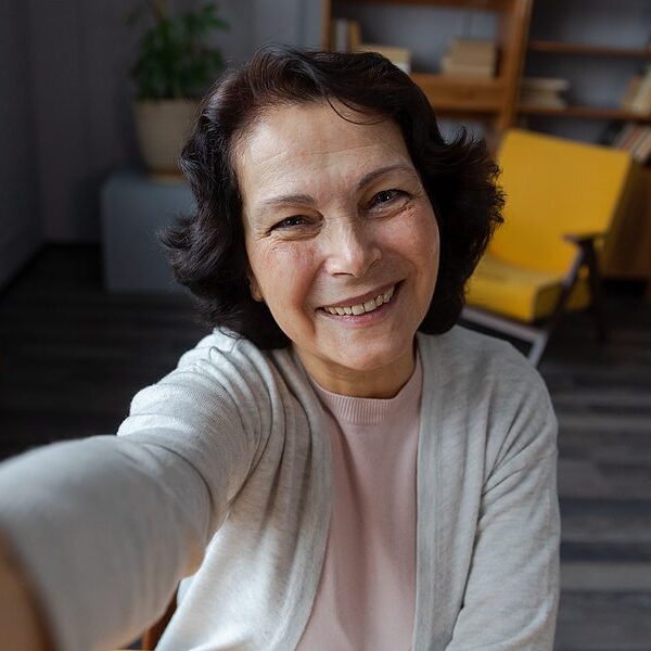 Happy Middle Aged Senior Woman Talk On Video Call With Friends Family. Laughing Mature Old Senior Gr Happy middle aged senior woman talk on video call with friends family. Laughing mature old senior grandmother having fun speaking with grown up children online. Headshot portrait selfie webcamera view